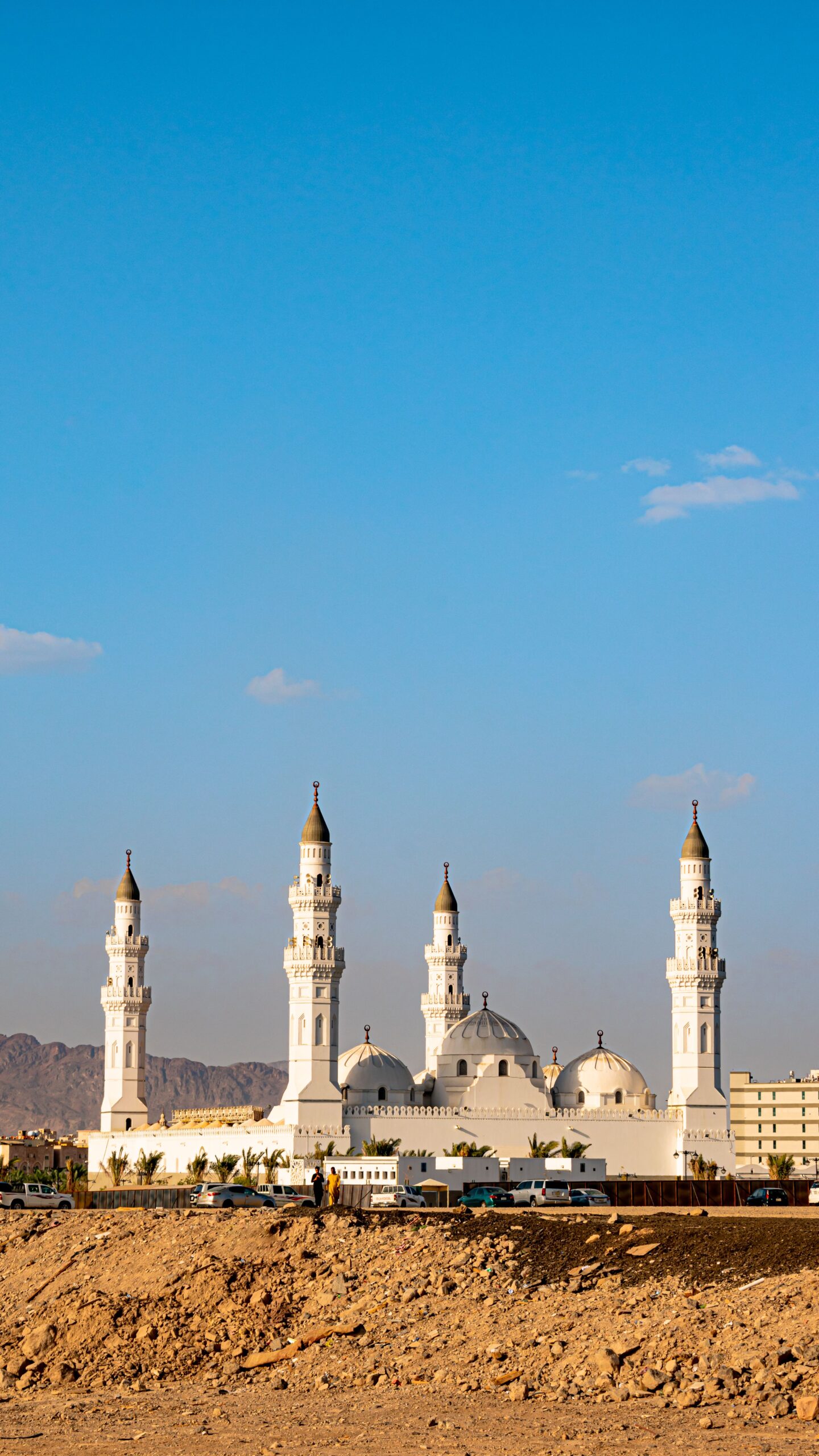 The iconic Quba Mosque in Madinah, Saudi Arabia, under a clear blue sky. A symbol of Islamic heritage.